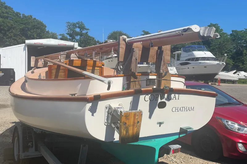 Slide: The Image of 1978 Marshall Sanderling sailboat named "Copycat" on trailer in a boatyard. - 10