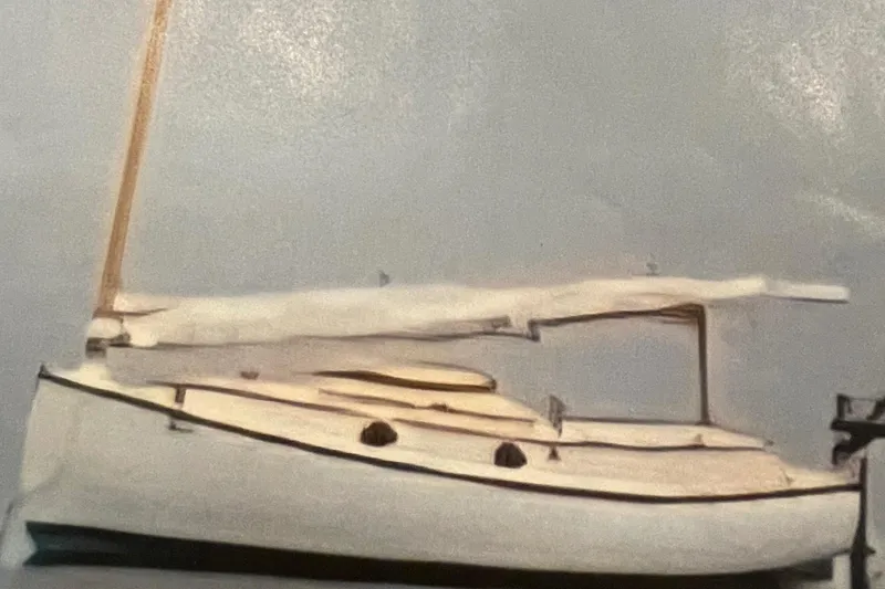 Slide: The Image of Vintage 1978 Marshall Sanderling sailboat with white sails and wooden mast. - 2