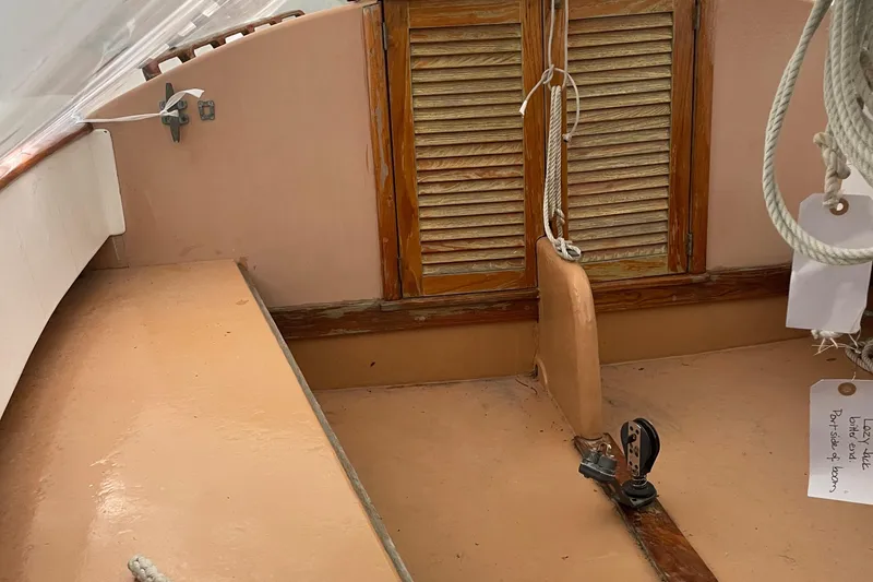 Slide: The Image of 1978 Marshall Sanderling sailboat cockpit with wooden hatch and rigging details. - 3