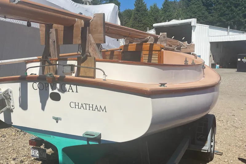 Slide: The Image of 1978 Marshall Sanderling sailboat named "Copy Cat" on trailer in sunny yard. - 9