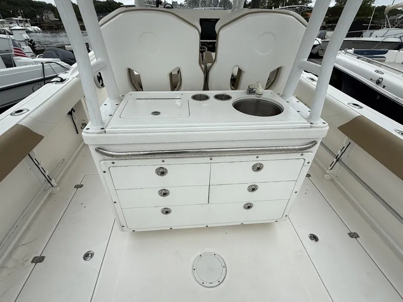 Slide: The Image of 2015 Edgewater 280CC boat interior with sink and storage drawers. - 12