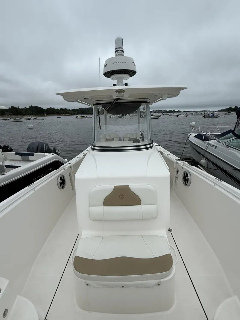 Slide: The Image of 2015 Edgewater 280CC boat on water, featuring a central console and seating area. - 14