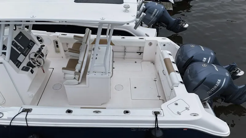 Slide: The Image of 2015 Edgewater 280CC boat with dual Yamaha engines, spacious deck, and modern helm controls. - 9