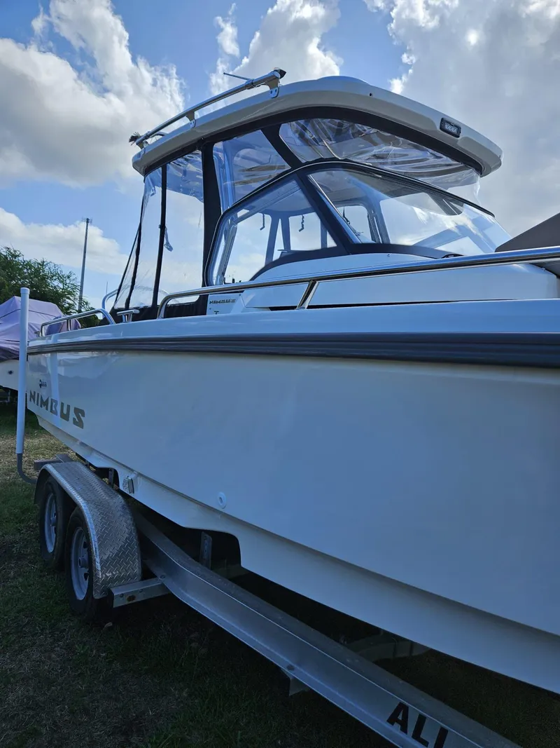 Slide: The Image of 2023 Nimbus Tender 8 boat on trailer under cloudy sky. - 16