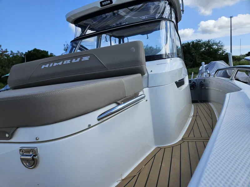 Slide: The Image of 2023 Nimbus Tender 8 boat with sleek design and modern features, docked outdoors. - 18