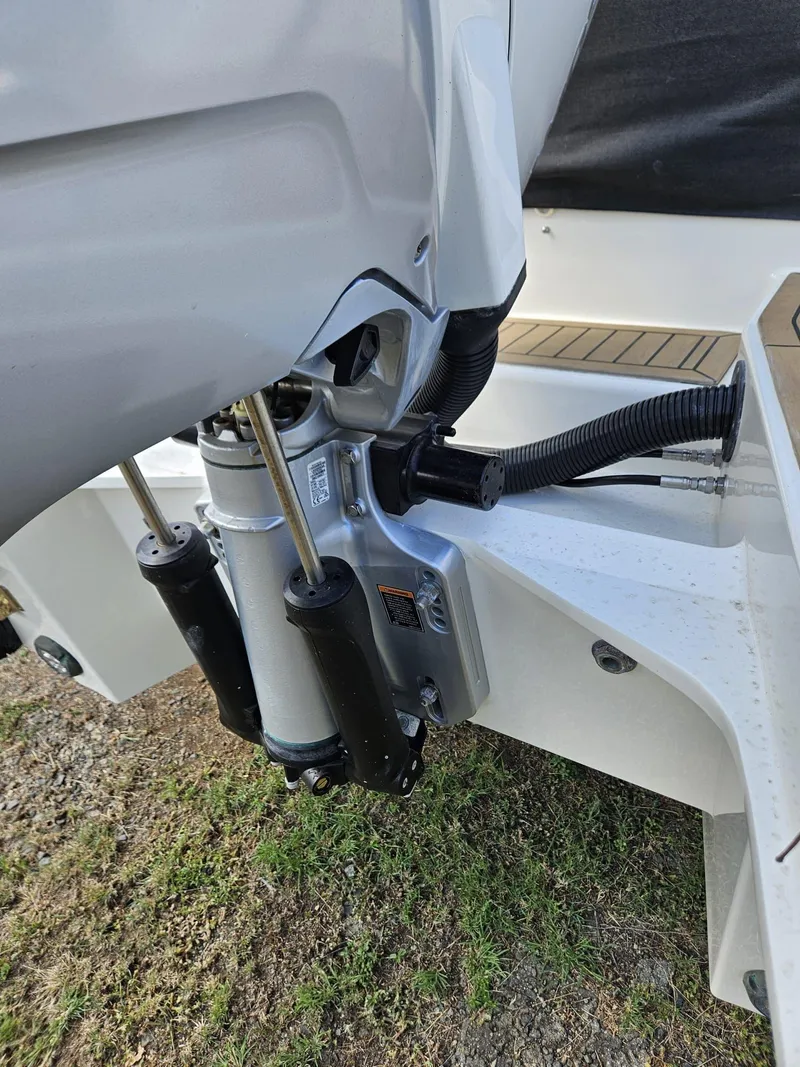 Slide: The Image of Close-up of 2023 Nimbus Tender 8 boat engine components on grass. - 21