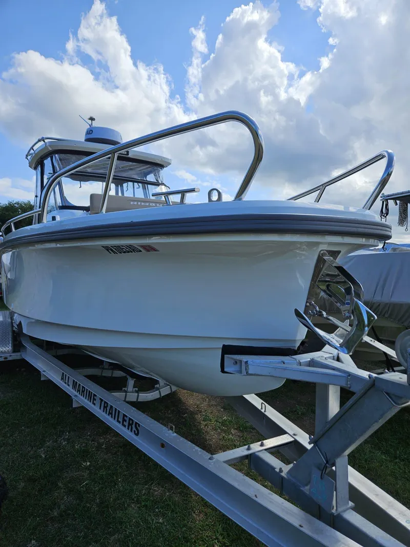 Slide: The Image of 2023 Nimbus Tender 8 boat on trailer under cloudy sky. - 3