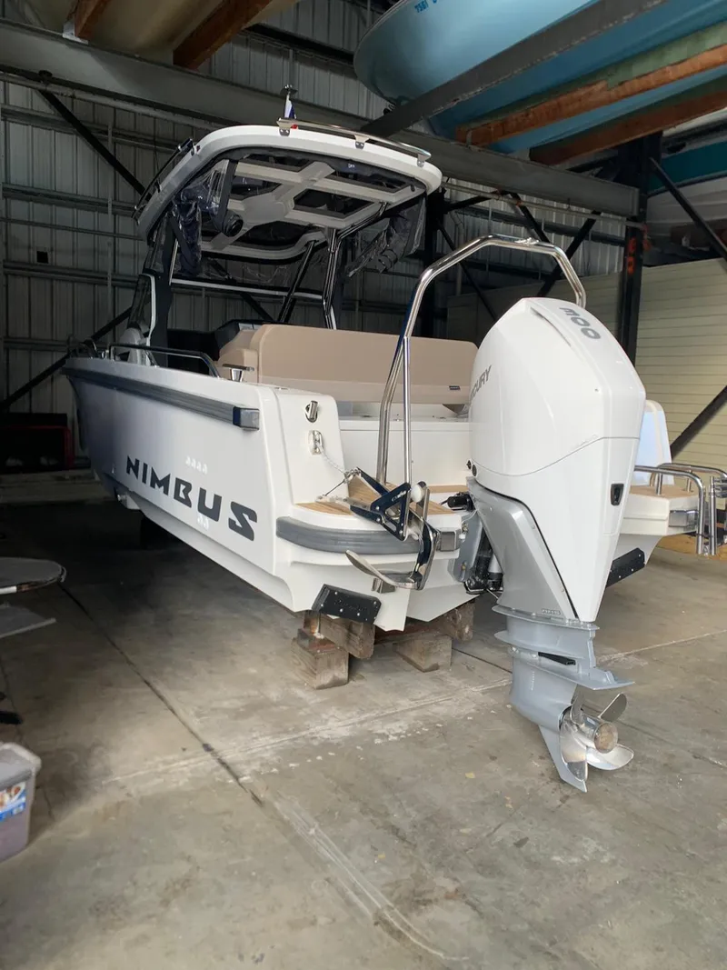 Slide: The Image of 2023 Nimbus Tender 8 boat with Mercury outboard motor in a storage facility. - 5