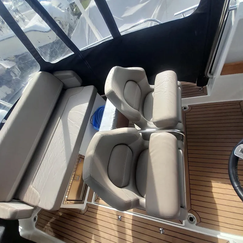 Slide: The Image of 2023 Nimbus Tender 8 interior with beige seating and wooden flooring. - 8