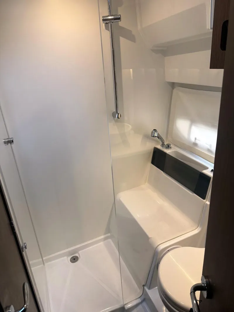 Slide: The Image of Modern bathroom interior of 2023 Beneteau Antares 11 OB boat, featuring shower and toilet. - 10