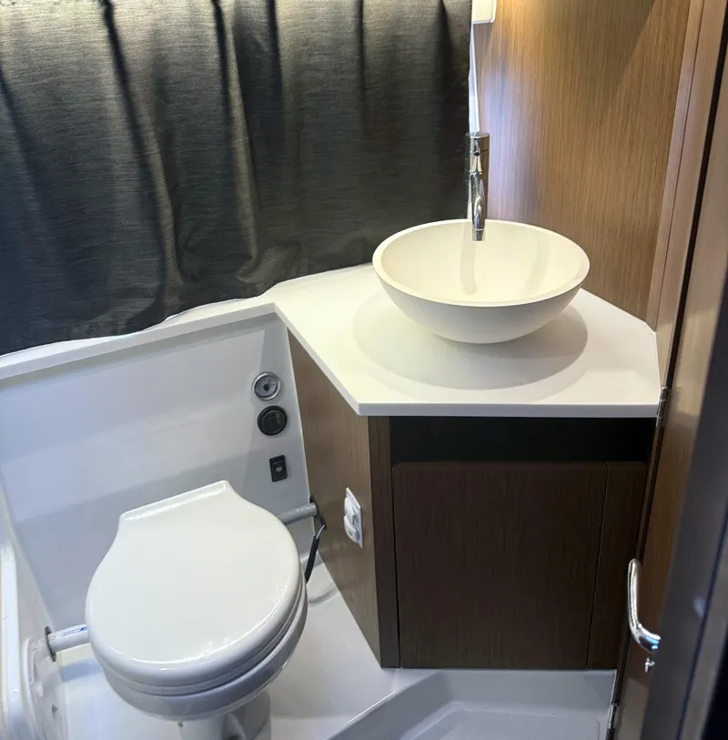 Slide: The Image of 2023 Beneteau Antares 11 OB bathroom with modern sink and toilet. - 12