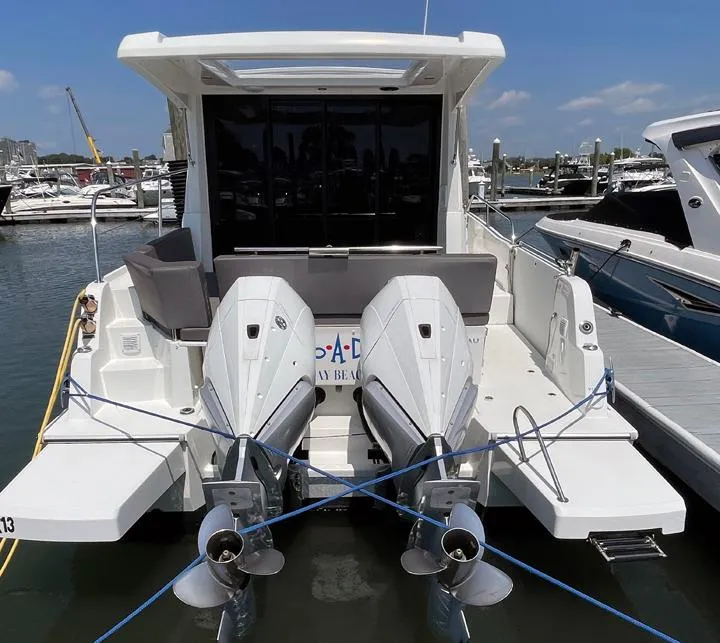 Slide: The Image of 2023 Beneteau Antares 11 OB with dual outboard engines docked at marina. - 15