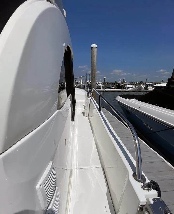Slide: The Image of 2023 Beneteau Antares 11 OB yacht docked at marina under clear blue sky. - 16