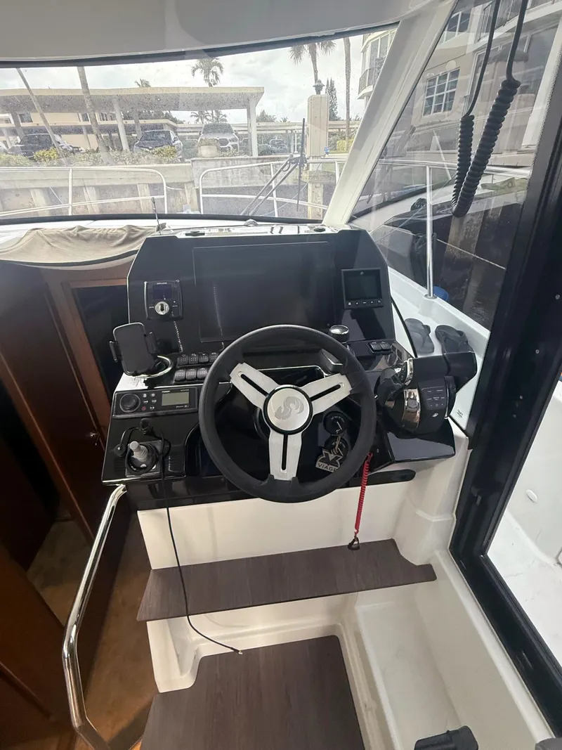 Slide: The Image of Helm of 2023 Beneteau Antares 11 OB with modern controls and steering wheel. - 7