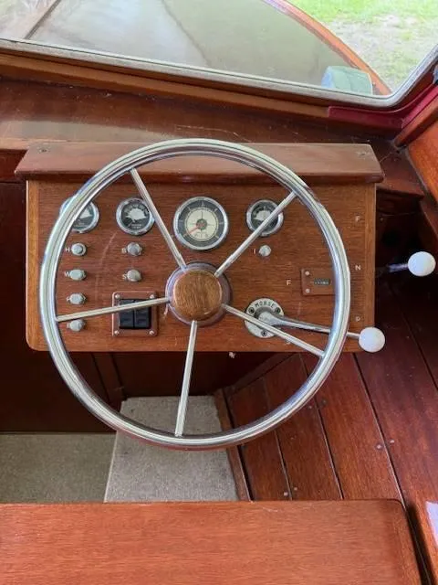 Slide: The Image of Vintage 1968 Lyman 19 boat dashboard with wooden steering wheel and classic gauges. - 10