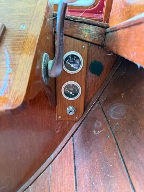 Slide: The Image of 1968 Lyman 19 boat dashboard with vintage gauges and wooden paneling. - 12