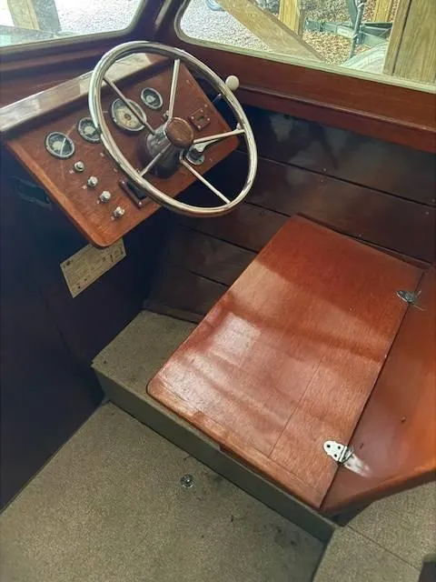 Slide: The Image of 1968 Lyman 19 boat cockpit with wooden steering wheel and vintage gauges. - 13