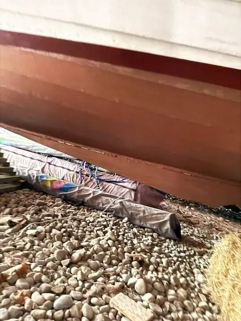 Slide: The Image of Bottom view of a 1968 Lyman 19 boat resting on pebbles. - 17