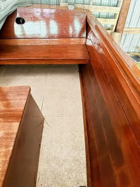 Slide: The Image of 1968 Lyman 19 boat interior with polished wooden seating and flooring. - 18