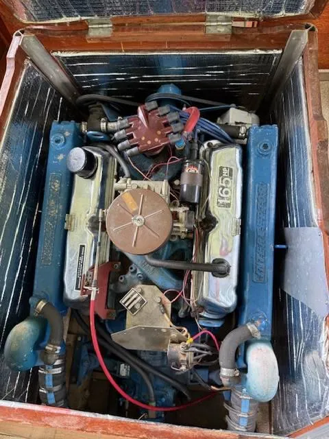 Slide: The Image of 1968 Lyman 19 engine, blue with visible components, in a wooden compartment. - 20