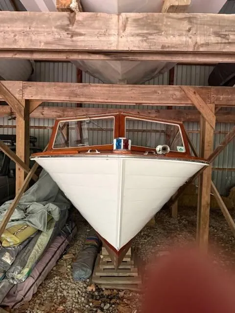 Slide: The Image of 1968 Lyman 19 boat stored in a wooden shed, front view. - 5