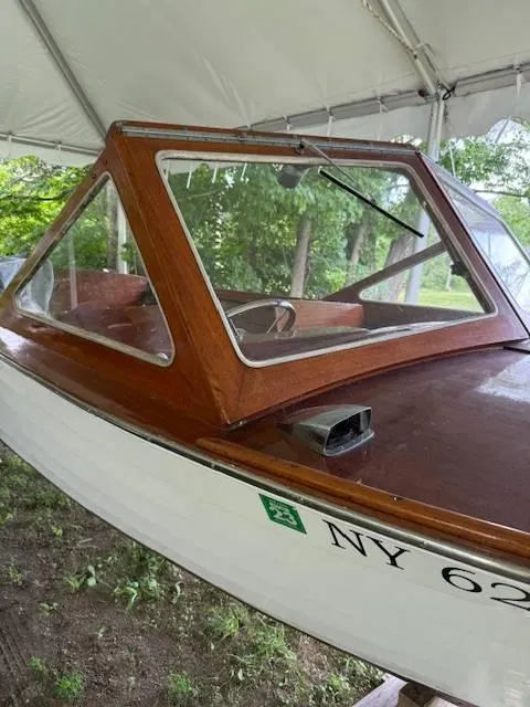 Slide: The Image of 1968 Lyman 19 boat with wooden cabin and windshield, under a canopy. - 7