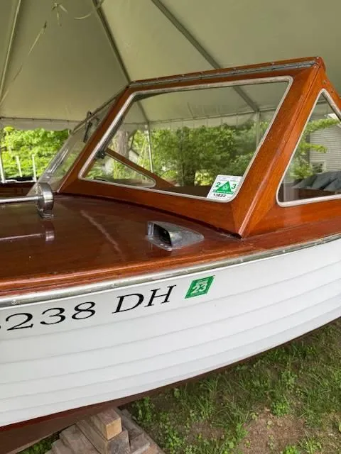 Slide: The Image of 1968 Lyman 19 boat with wooden cabin under a tent, displaying registration number 238 DH. - 8