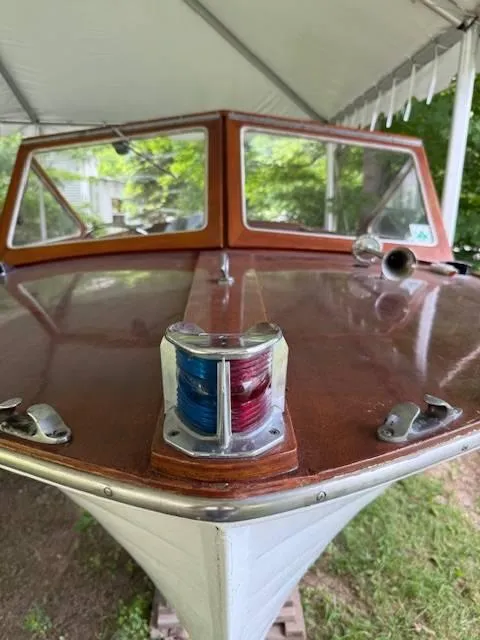 Slide: The Image of 1968 Lyman 19 boat with wooden deck and navigation lights under a canopy. - 9