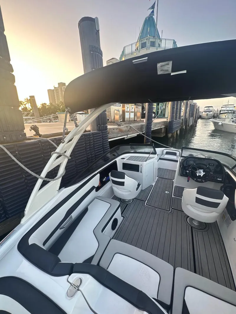 Slide: The Image of 2023 Yamaha AR195S boat interior at dock, featuring sleek seating and modern controls. - 3