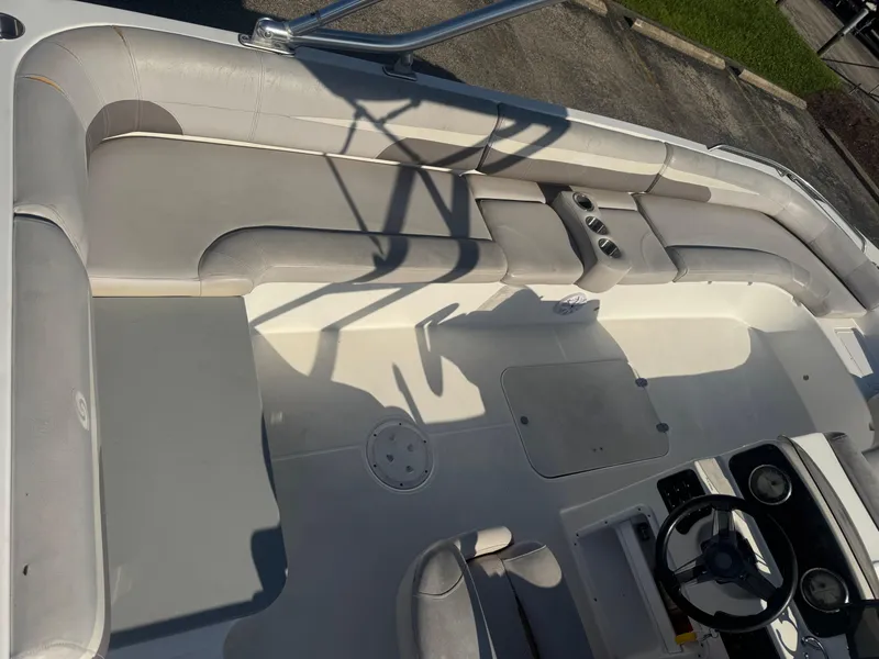 Slide: The Image of 2017 Hurricane SunDeck Sport 201 OB interior with seating and steering wheel. - 11