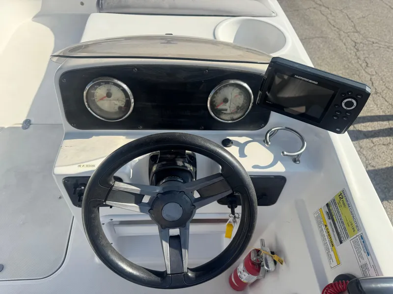 Slide: The Image of 2017 Hurricane SunDeck Sport 201 OB boat dashboard with steering wheel and gauges. - 7