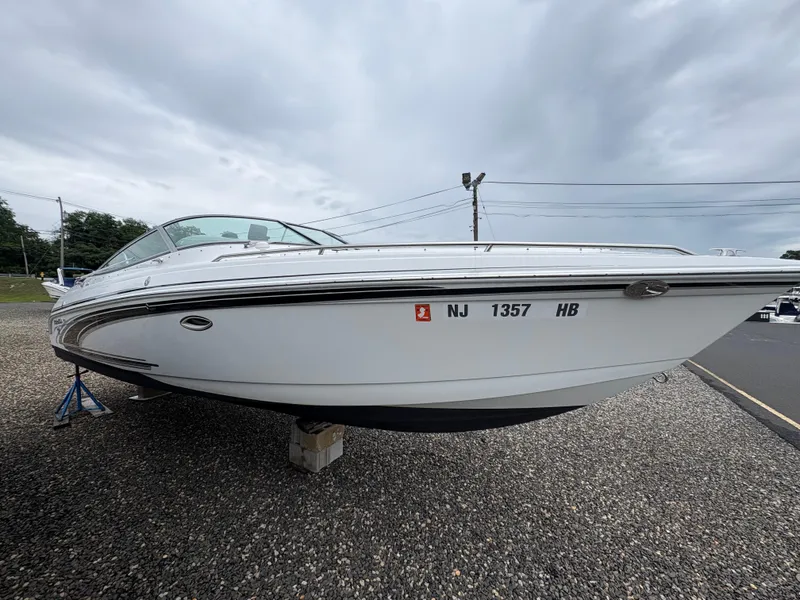 Slide: The Image of 2004 Formula 260 Bowrider boat on stands, displayed outdoors under cloudy skies. - 1