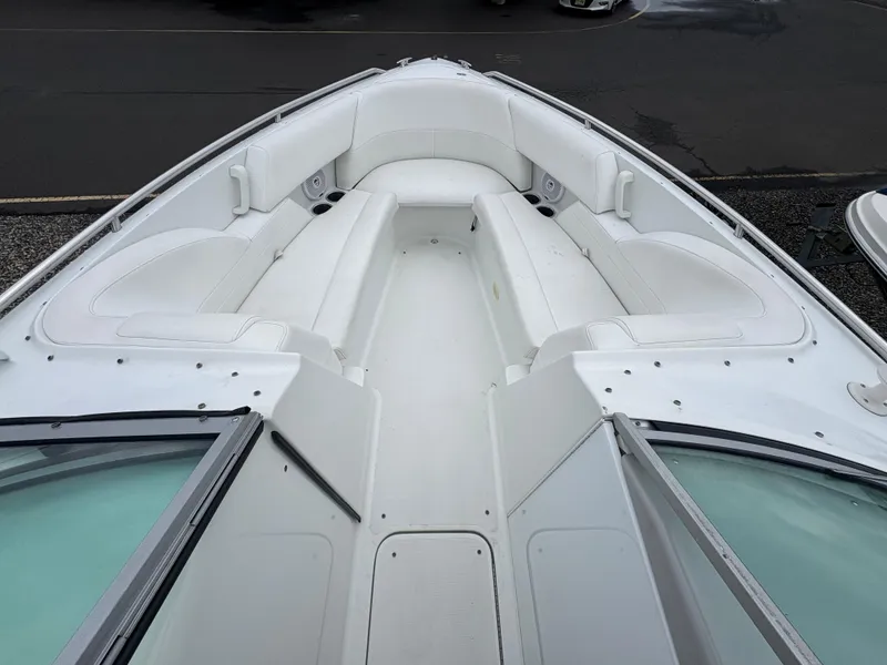 Slide: The Image of 2004 Formula 260 Bowrider boat with spacious white seating and sleek design. - 11