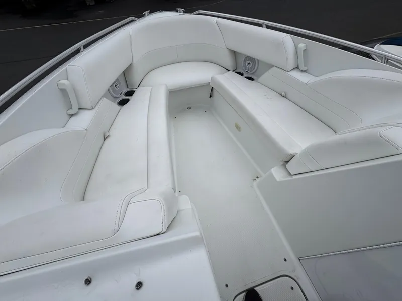 Slide: The Image of 2004 Formula 260 Bowrider boat interior with white seating and cup holders. - 12