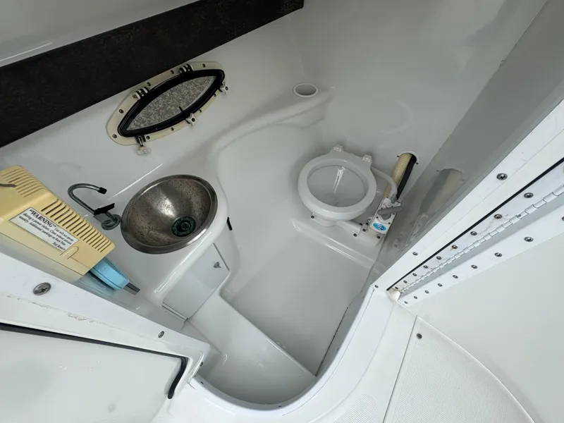 Slide: The Image of 2004 Formula 260 Bowrider boat bathroom with sink and toilet. - 14
