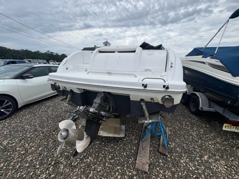 Slide: The Image of 2004 Formula 260 Bowrider boat on stands, rear view, cloudy sky background. - 5