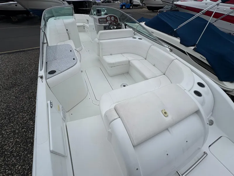 Slide: The Image of 2004 Formula 260 Bowrider boat interior with white seating and dashboard. - 7