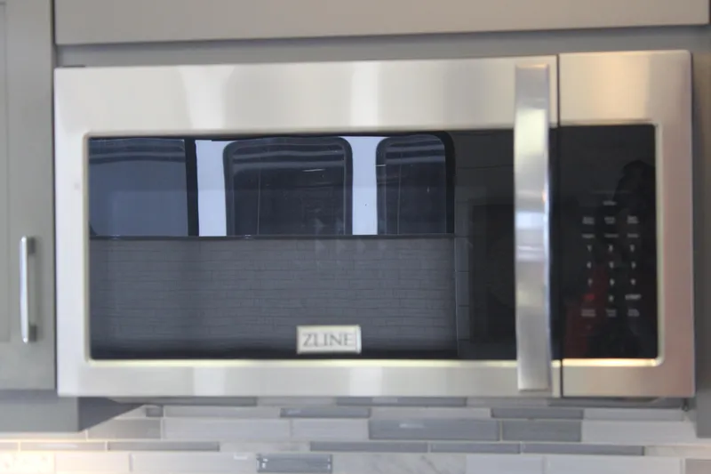 Slide: The Image of Small beverage fridge with drinks, set in a modern white interior on a Sumerset 66, 1992 model. - 13