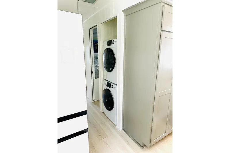 Slide: The Image of Stainless steel Wolf oven with red knobs, surrounded by gray cabinetry. - 15