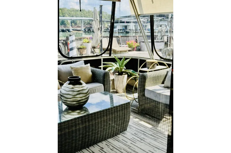 Slide: The Image of 1992 Sumerset 66 houseboat on a calm lake with forested shoreline. - 2