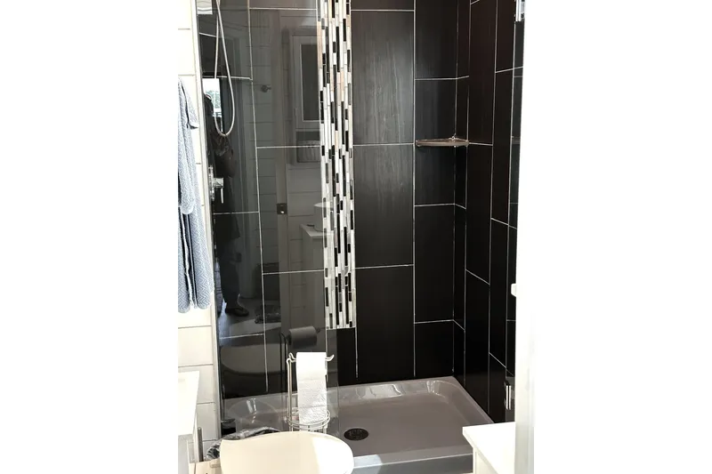 Slide: The Image of Cozy Sumerset 66 interior with TV, boat painting, and striped bedding, 1992 model. - 22