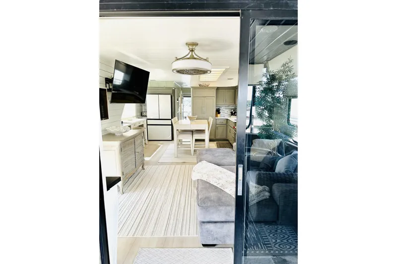 Slide: The Image of 1992 Sumerset 66 houseboat docked under a clear blue sky. - 3