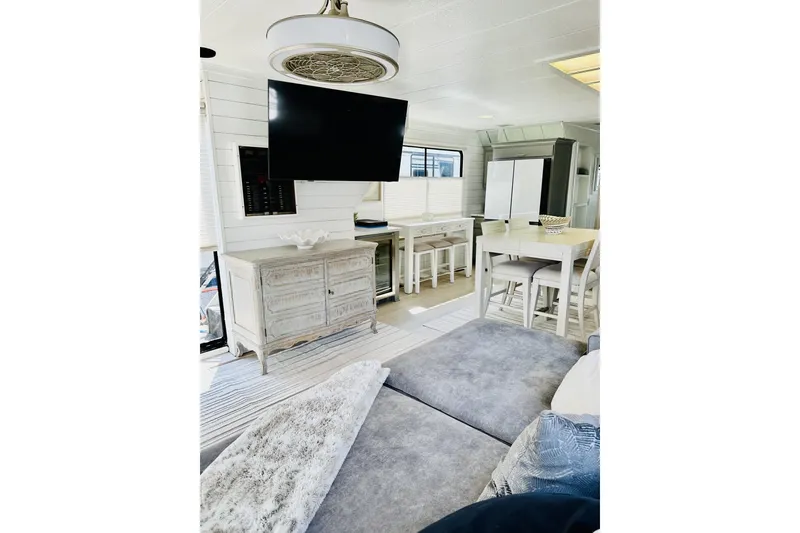 Slide: The Image of Luxurious 1992 Sumerset 66 houseboat interior with modern seating and scenic lake view. - 4