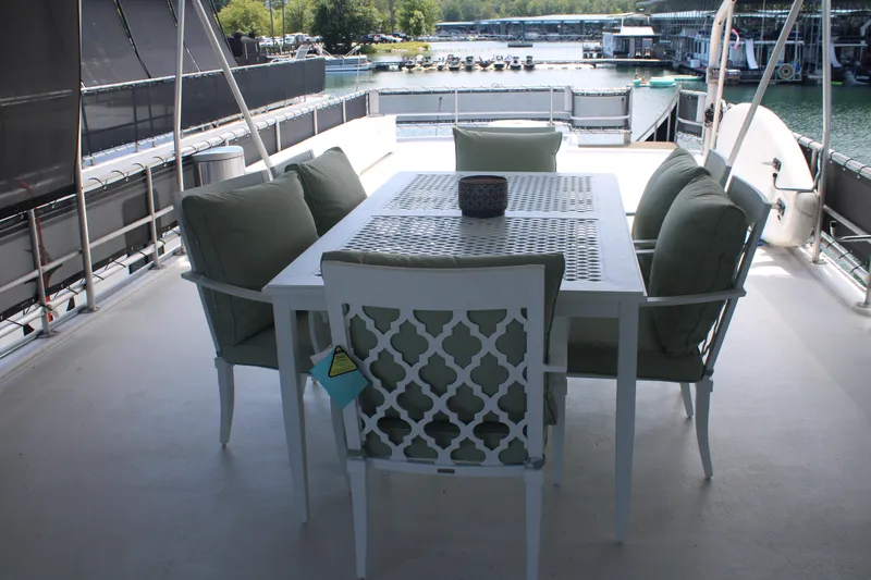 Slide: The Image of 1992 Sumerset 66 houseboat docked, featuring outdoor deck and spiral staircase. - 43