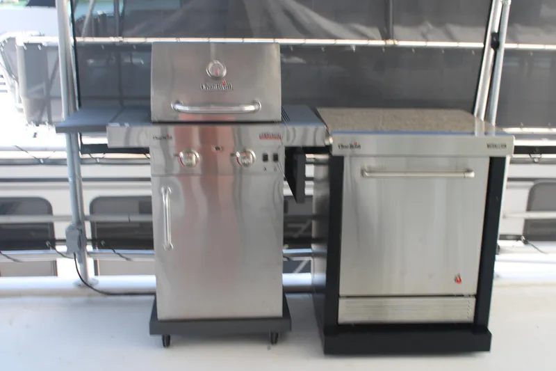 Slide: The Image of Covered deck of a 1992 Sumerset 66 houseboat with dining area and scenic lake view. - 45