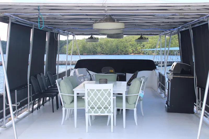 Slide: The Image of 1992 Sumerset 66 houseboat interior with outdoor seating, overlooking marina and water. - 47