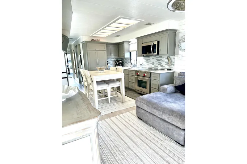 Slide: The Image of Luxurious 1992 Sumerset 66 houseboat interior with elegant wicker furniture and decorative plants. - 5