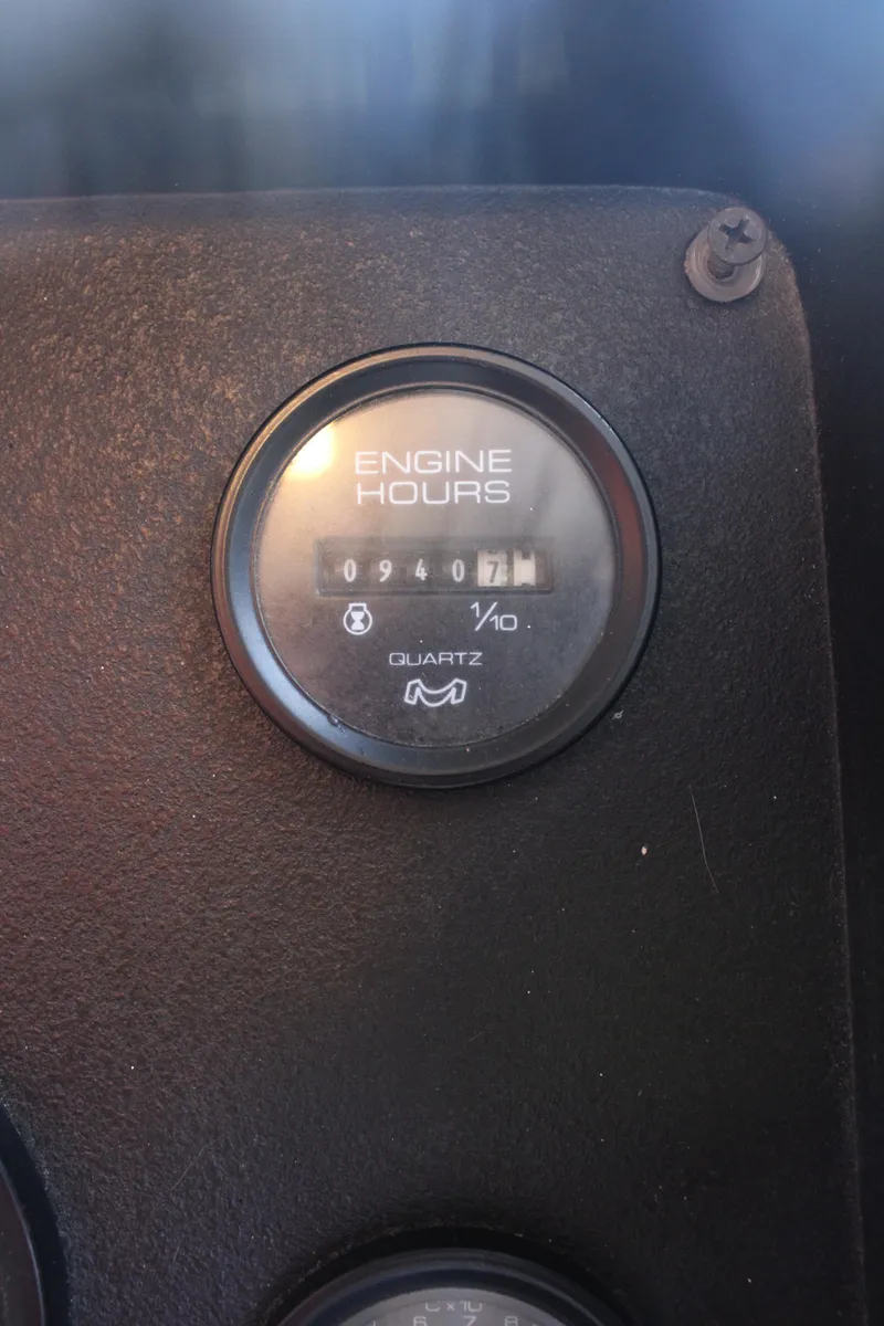 Slide: The Image of Control panel of a 1992 Sumerset 66 boat with gauges and steering wheel. - 53