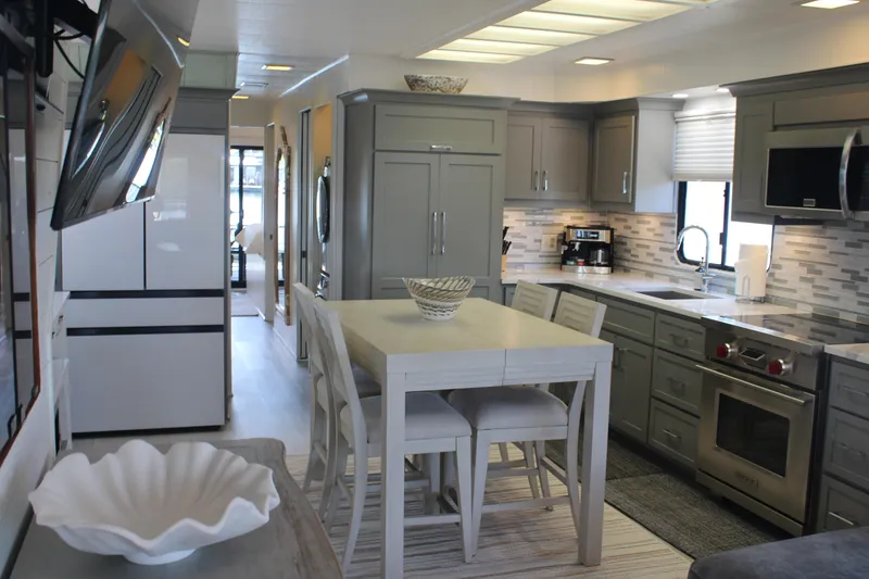 Slide: The Image of Interior view from a 1992 Sumerset 66 houseboat, overlooking a serene lake and dock. - 57