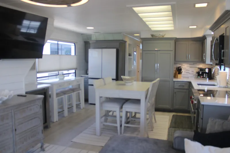 Slide: The Image of Interior view of a 1992 Sumerset 66 houseboat with lakefront seating area. - 59